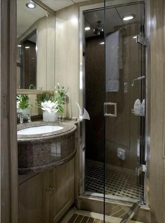 a bathroom with a glass shower aboard ALTHEA Yacht for Sale