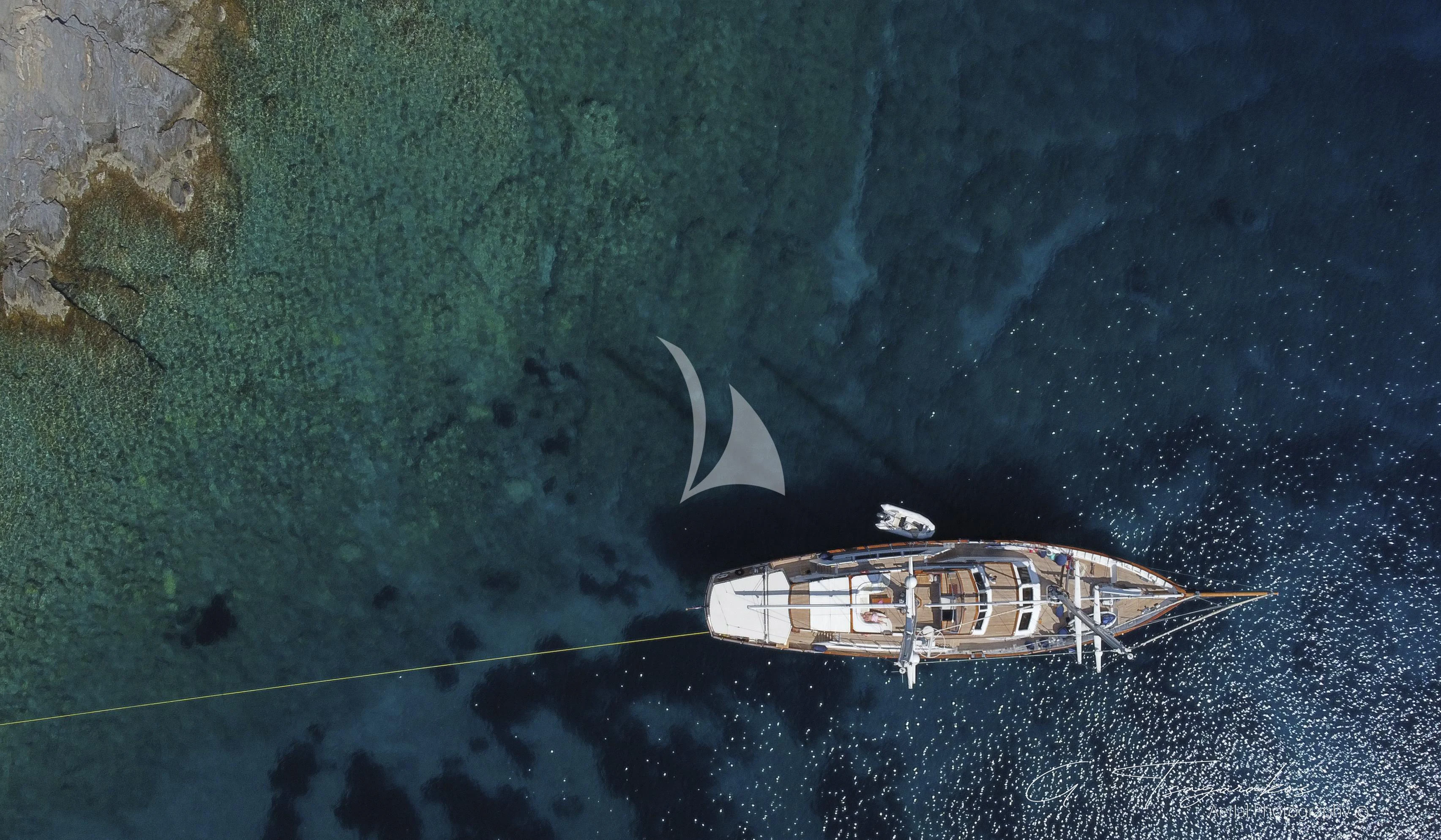 a helicopter flying over a body of water aboard ALTHEA Yacht for Sale