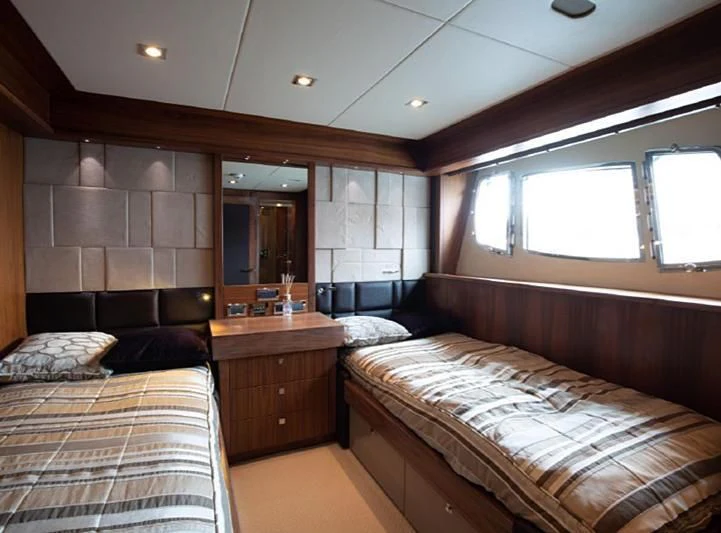 a room with a bed and a couch aboard BARBIZON Yacht for Sale