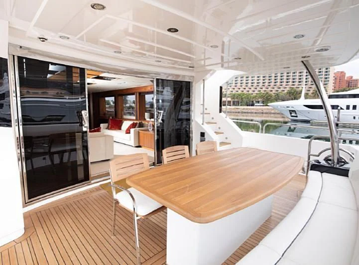 a room with a table and chairs aboard BARBIZON Yacht for Sale