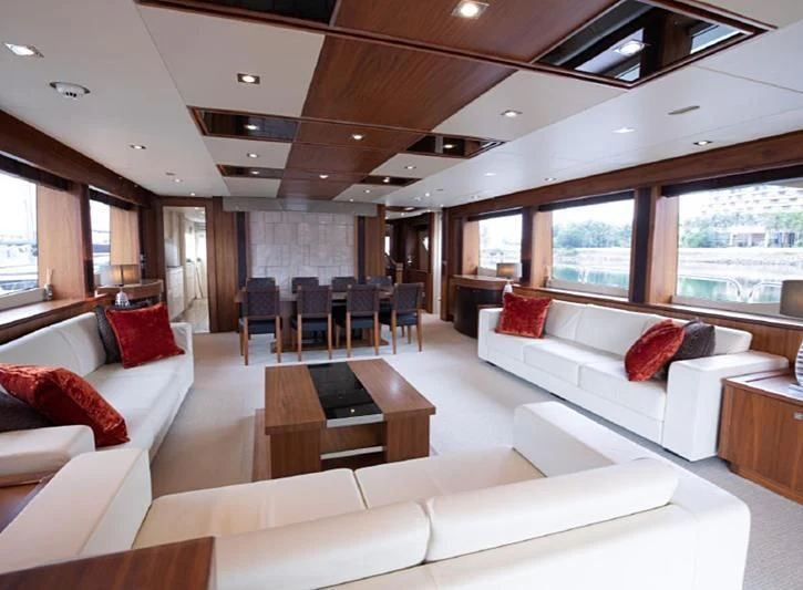 a living room with a couch and a table aboard BARBIZON Yacht for Sale