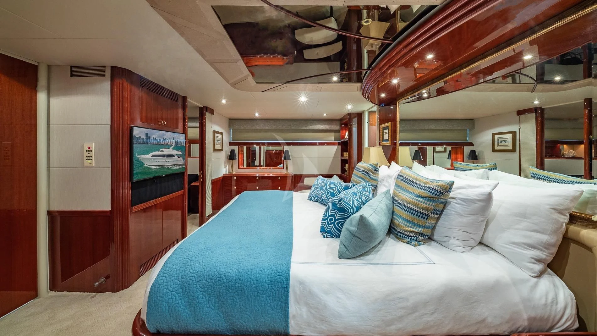 a bed with blue and white pillows aboard TRANQUILITY IV Yacht for Sale