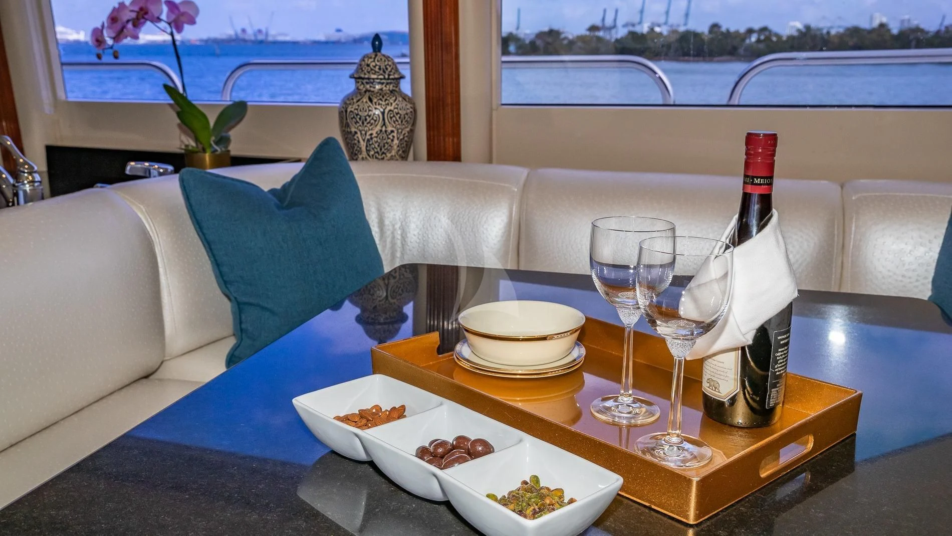 a table with food and wine bottles on it aboard TRANQUILITY IV Yacht for Sale