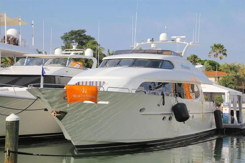 a white yacht in a harbor aboard TRANQUILITY IV Yacht for Sale