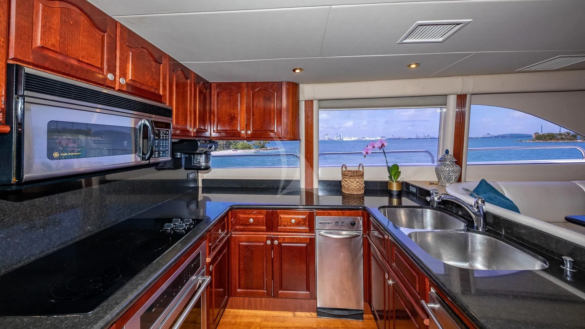 a kitchen with wooden cabinets aboard TRANQUILITY IV Yacht for Sale