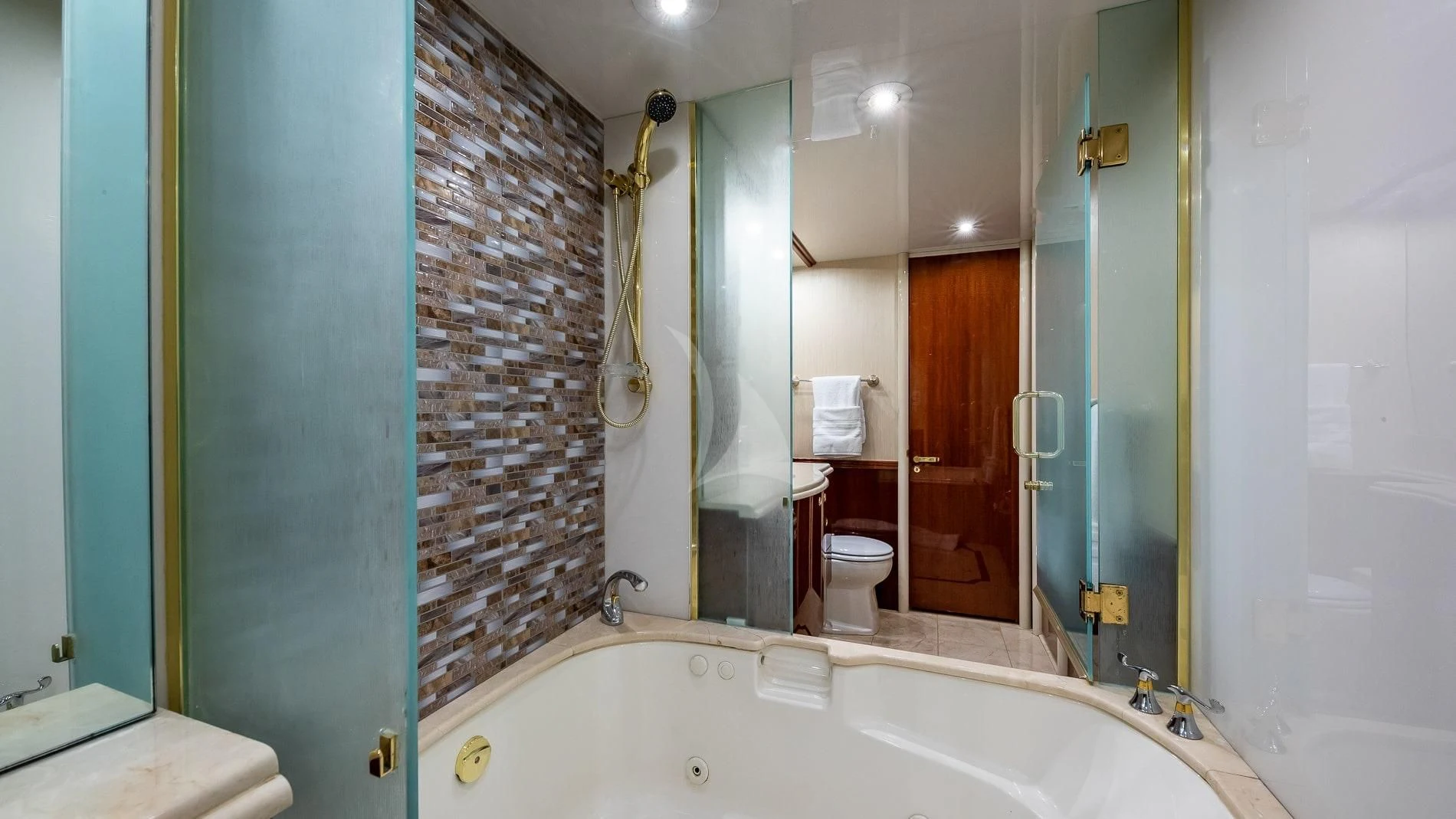 a bathroom with a tub and shower aboard TRANQUILITY IV Yacht for Sale