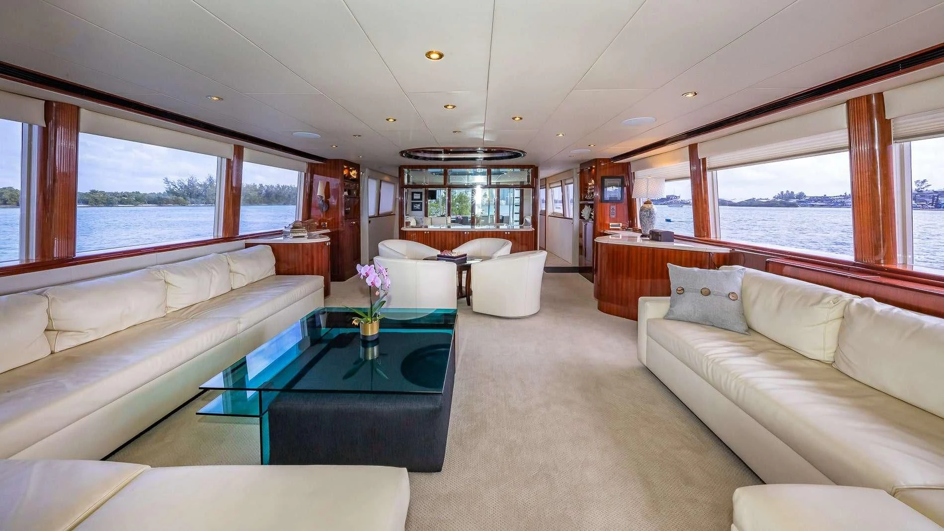 a living room with a table and couches aboard TRANQUILITY IV Yacht for Sale