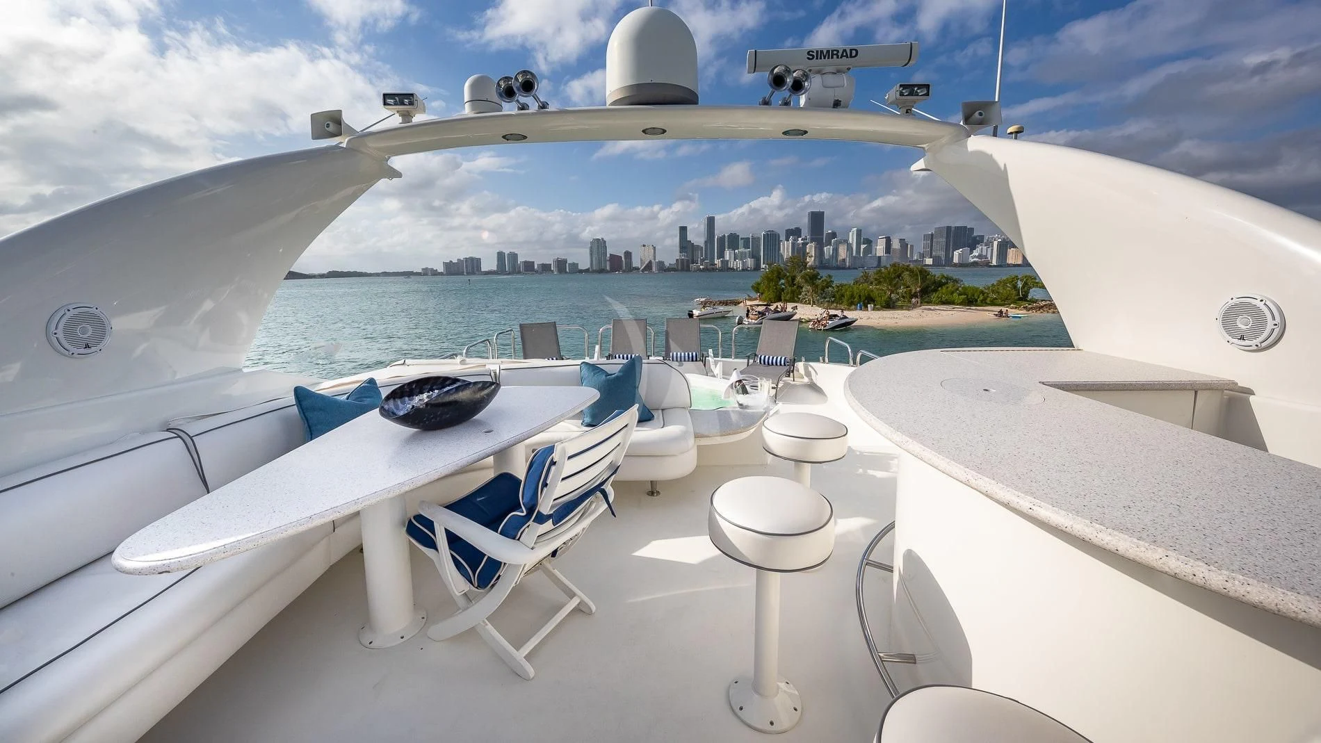 a white yacht with a large city in the background aboard TRANQUILITY IV Yacht for Sale