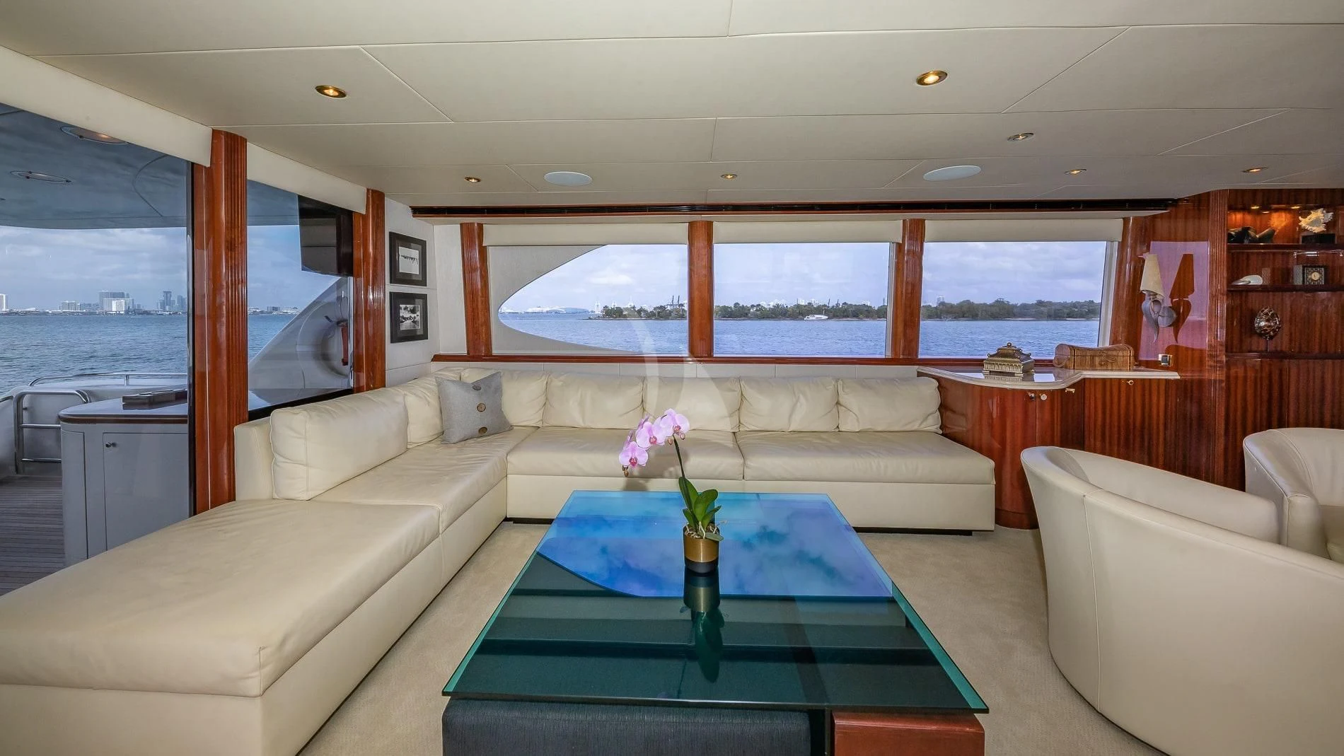 a living room with a large blue table and a large window aboard TRANQUILITY IV Yacht for Sale