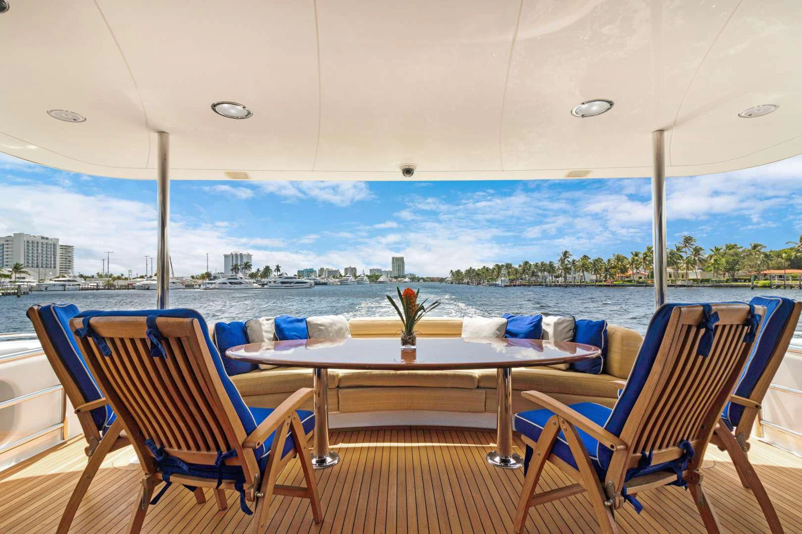 a table and chairs on a deck overlooking a city aboard TRANQUILITY IV Yacht for Sale