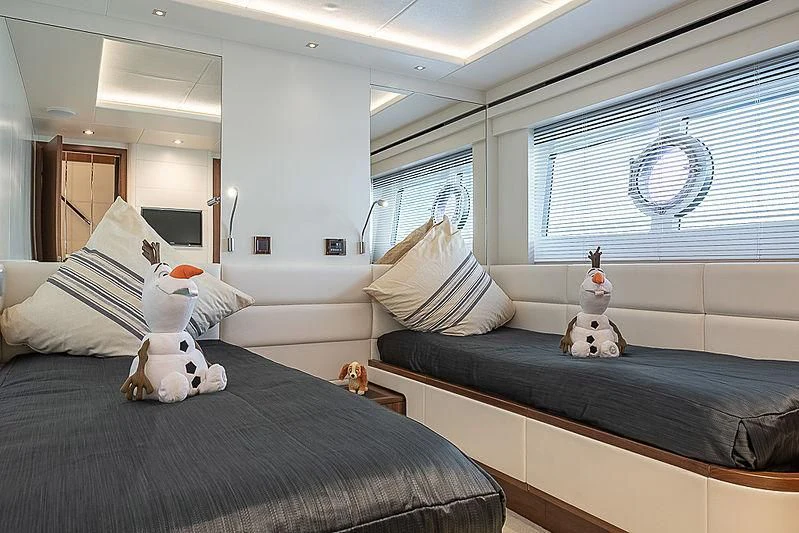 a bedroom with a couple of stuffed animals on the bed aboard RUSH X Yacht for Sale