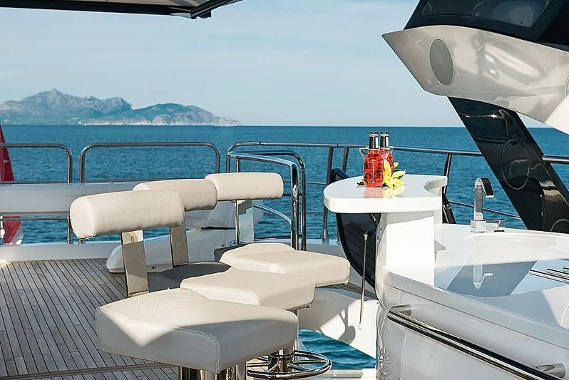 a boat with a table and chairs on it aboard RUSH X Yacht for Sale