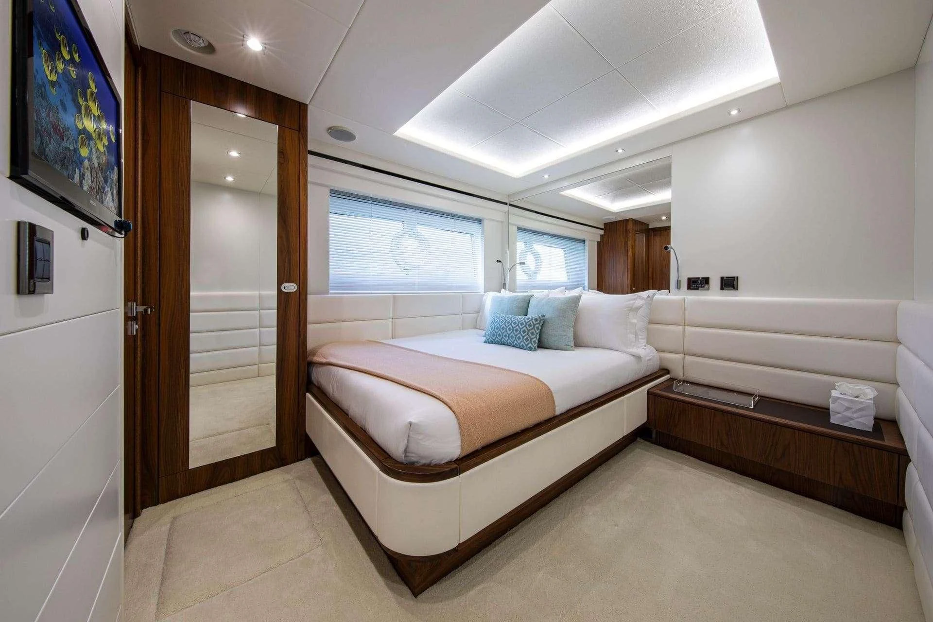 a bedroom with a bed and a desk aboard RUSH X Yacht for Sale