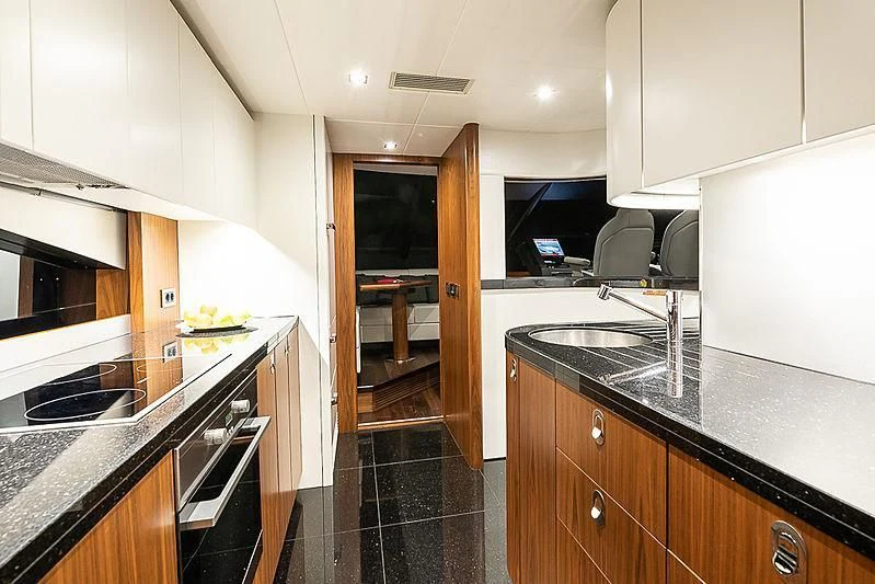 a kitchen with black counter tops aboard RUSH X Yacht for Sale