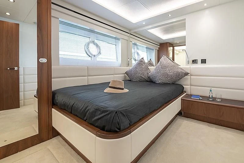 a bed with a blue blanket aboard RUSH X Yacht for Sale