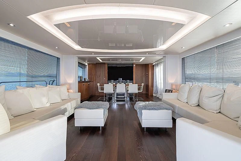 a large living room with white couches and a large window aboard RUSH X Yacht for Sale