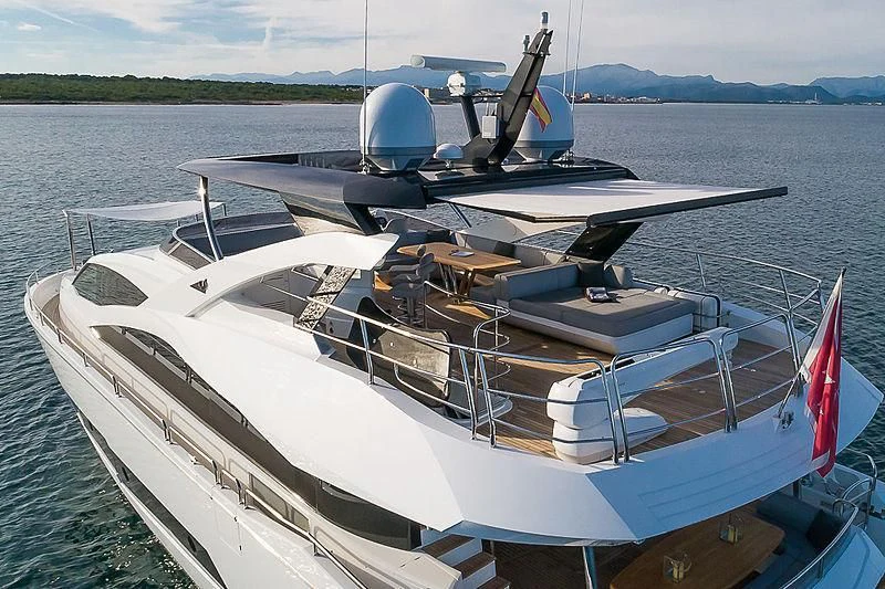 a boat with a red and white flag on the front aboard RUSH X Yacht for Sale
