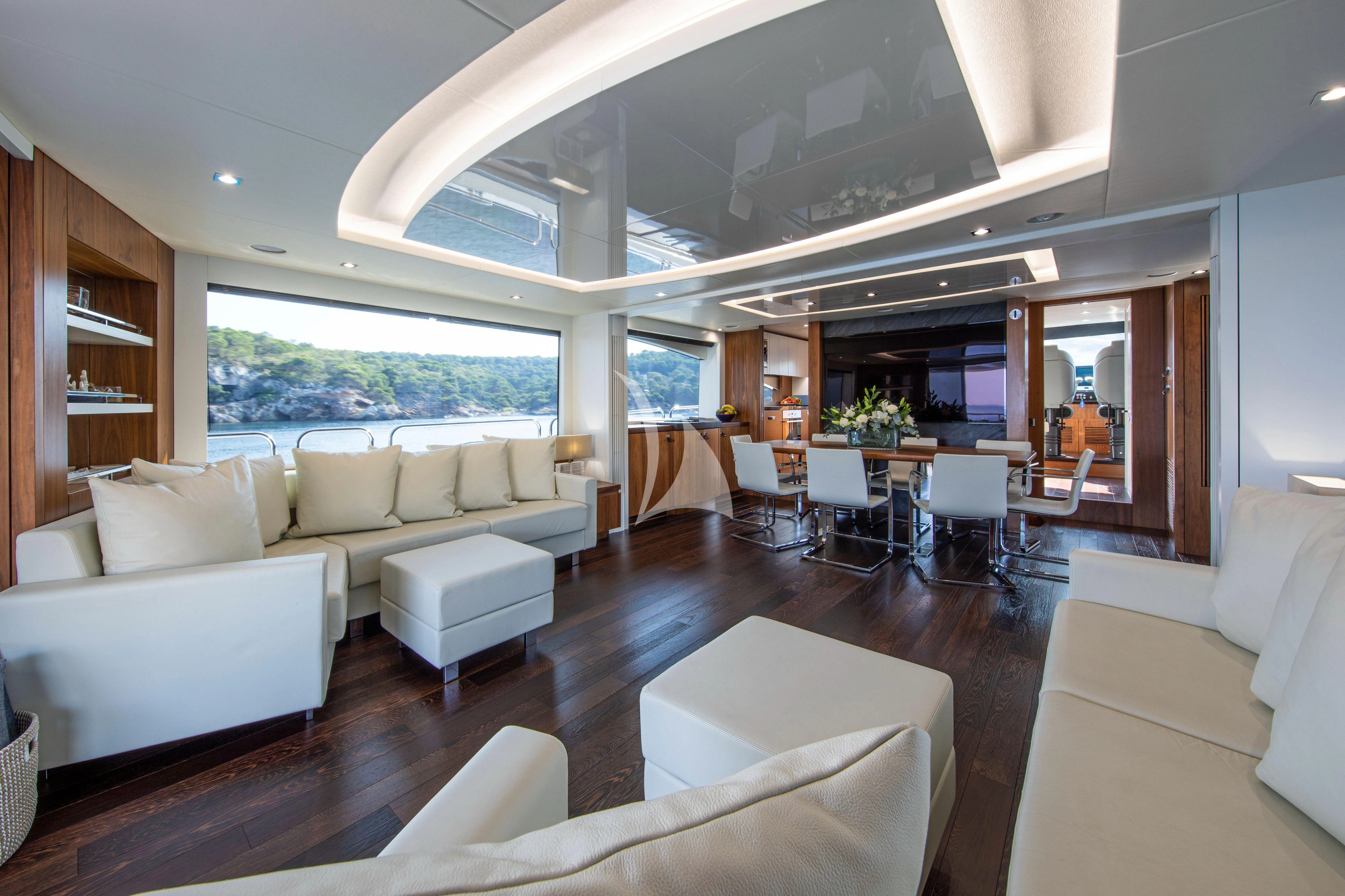 a living room with a large window aboard RUSH X Yacht for Sale