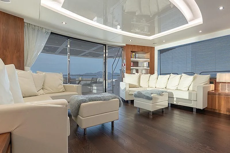 a living room with a large window aboard RUSH X Yacht for Sale
