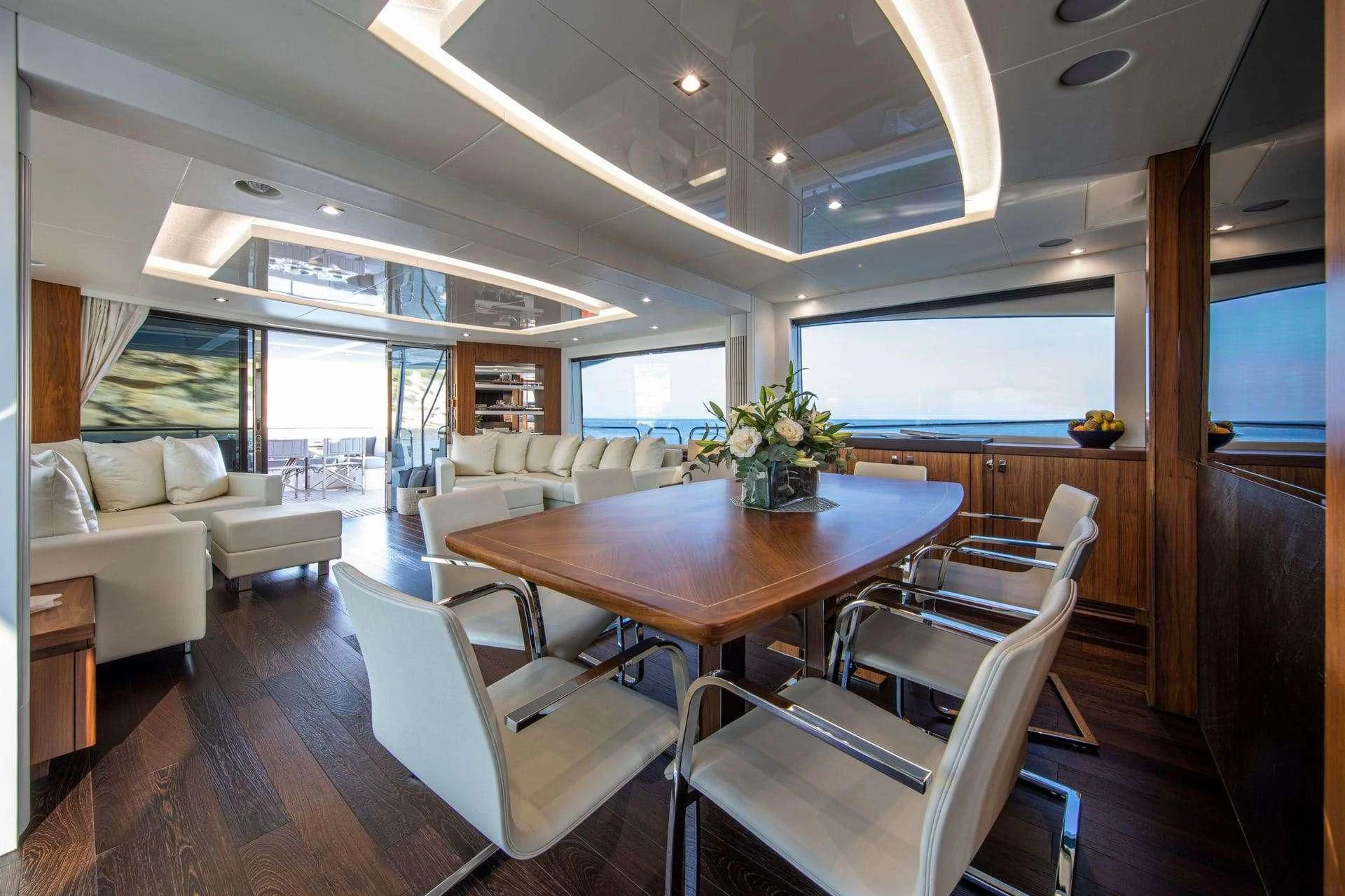 a living room with a table and chairs aboard RUSH X Yacht for Sale
