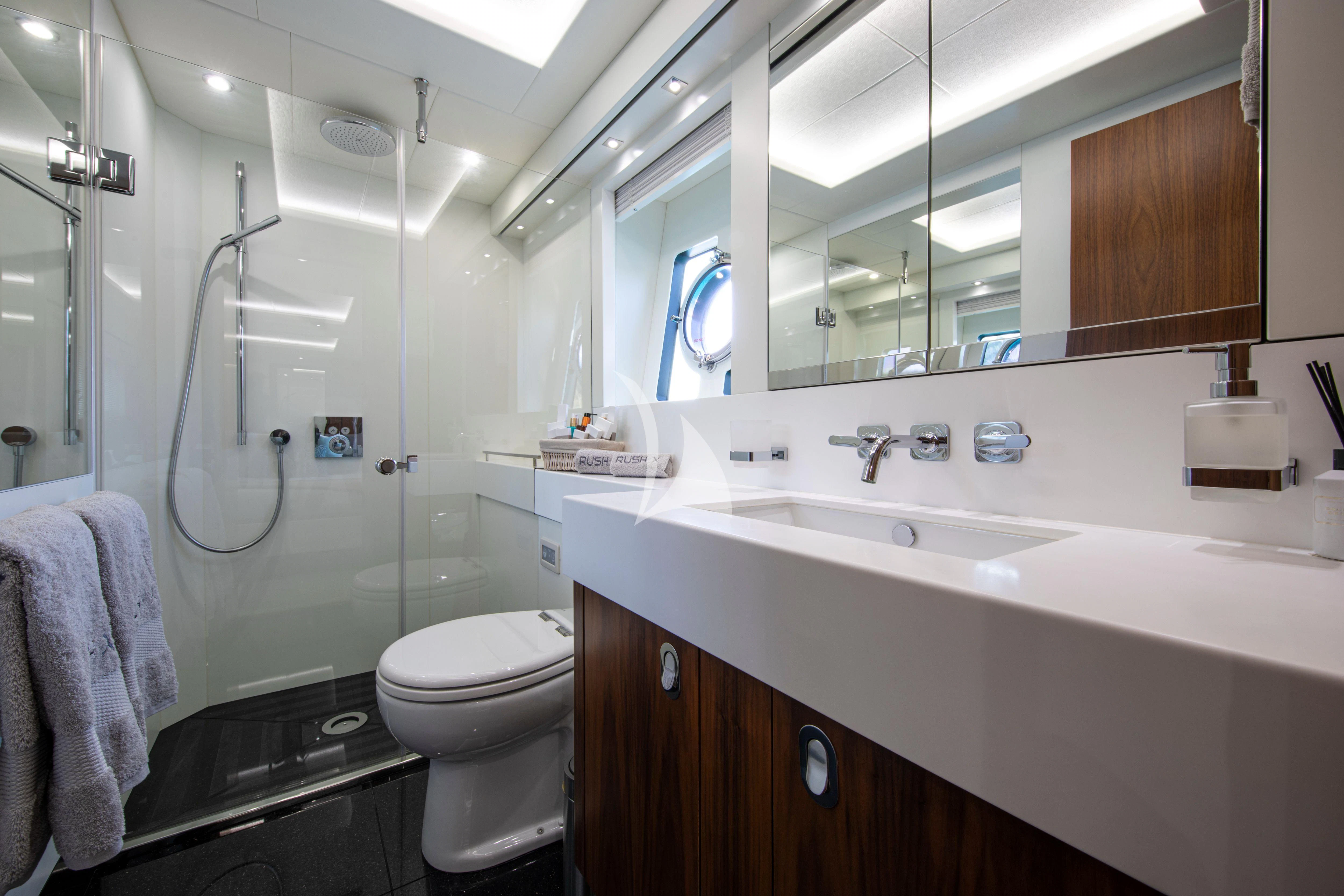 a bathroom with a glass shower aboard RUSH X Yacht for Sale