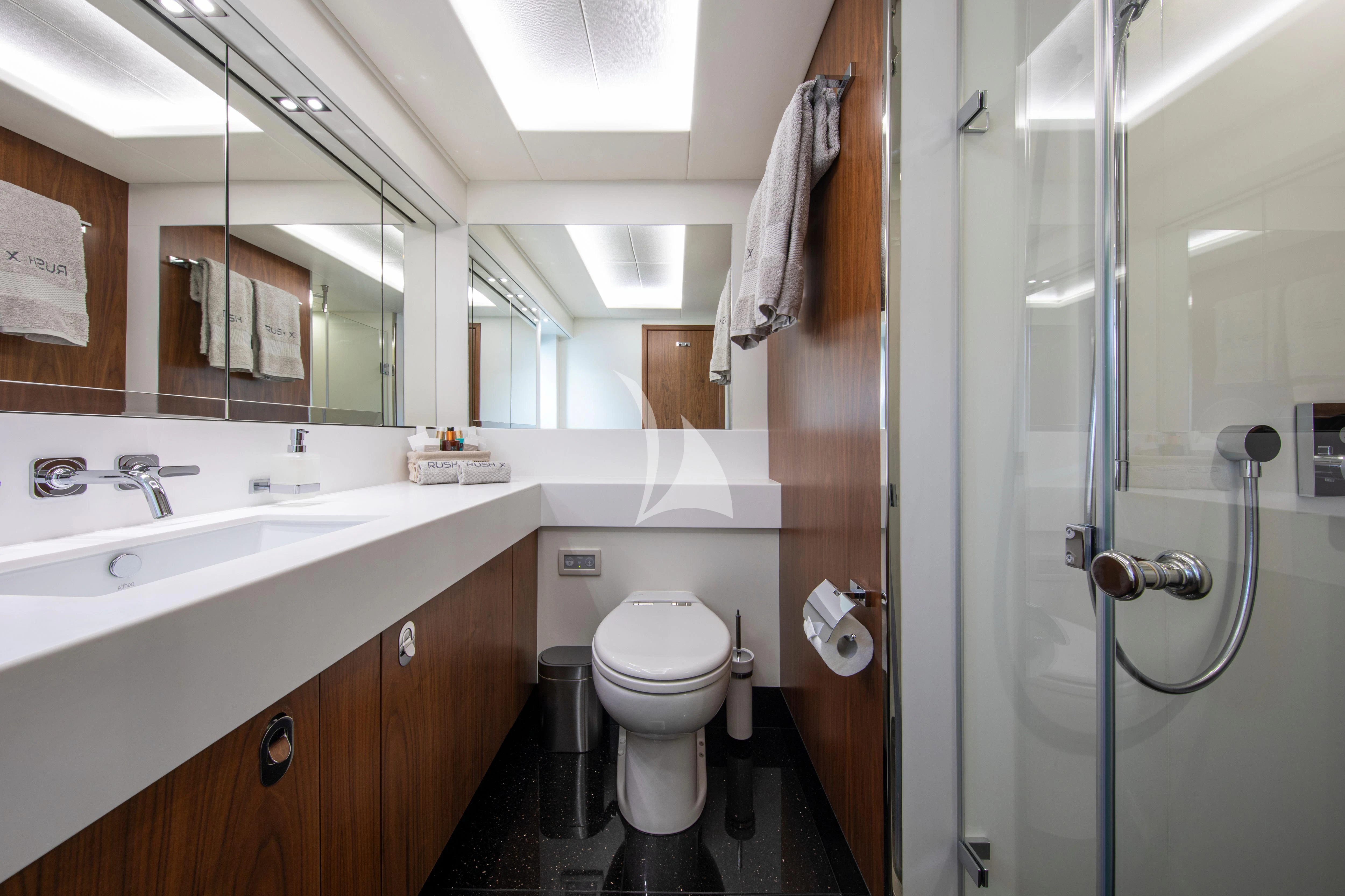 a bathroom with a toilet sink and a shower unit aboard RUSH X Yacht for Sale
