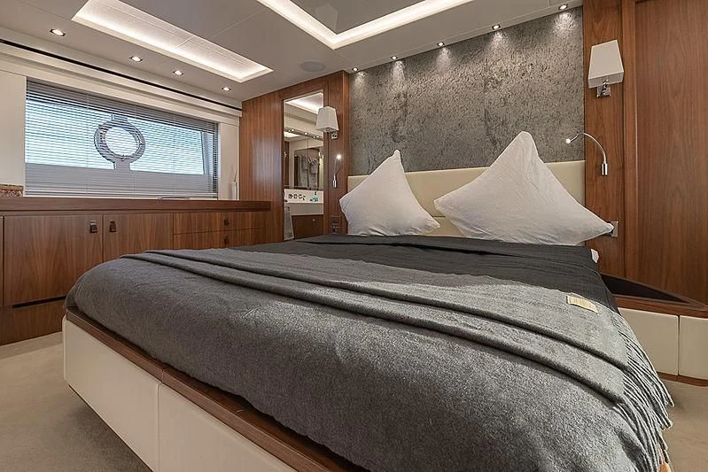 a bed with a black comforter aboard RUSH X Yacht for Sale