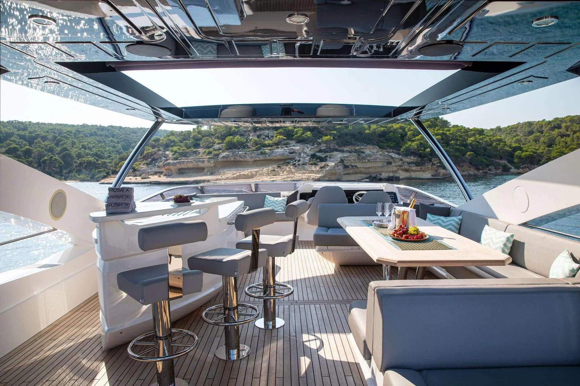 a room with a table and chairs aboard RUSH X Yacht for Sale