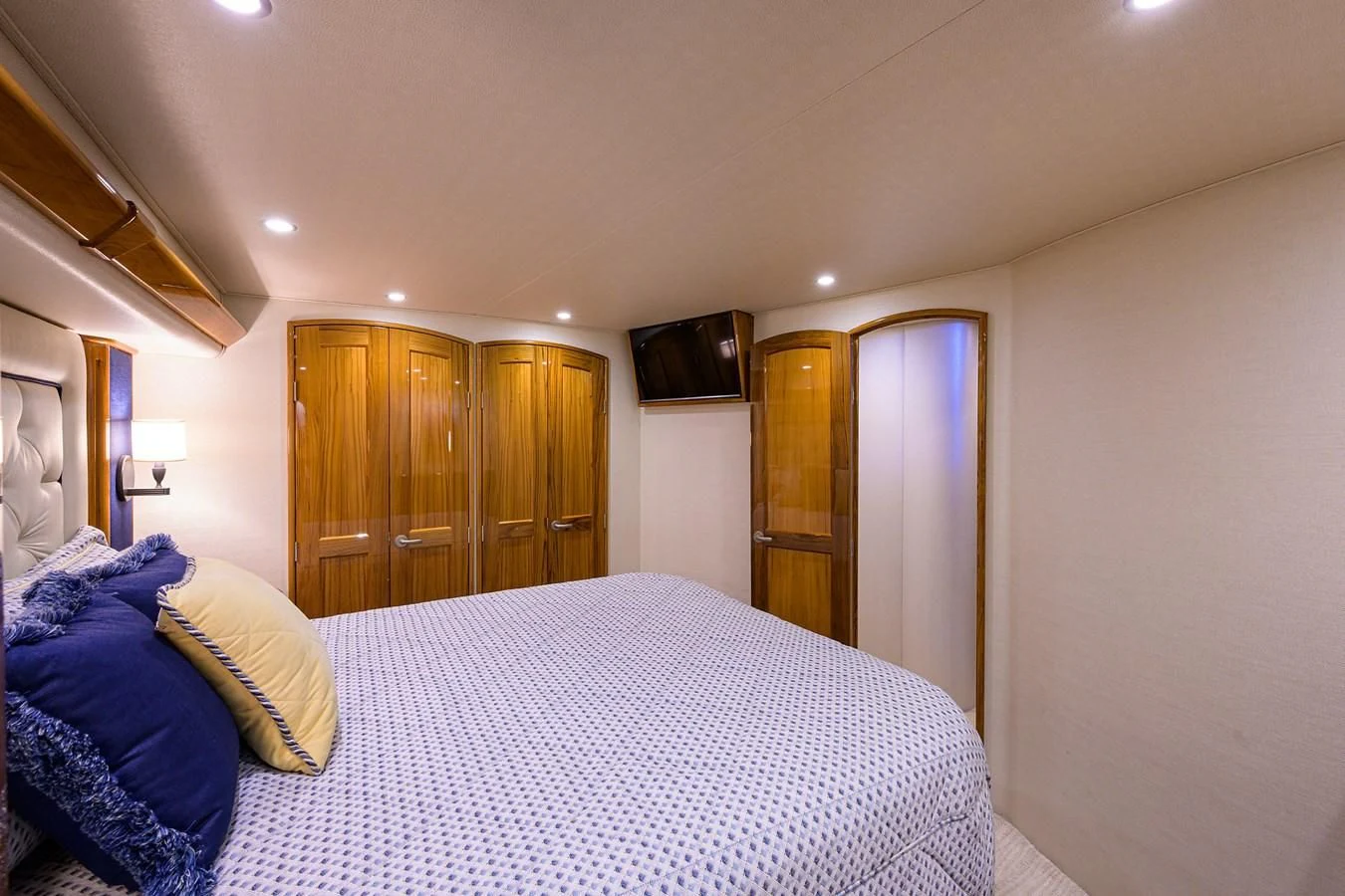 a bedroom with a bed and a television aboard TORO Yacht for Sale