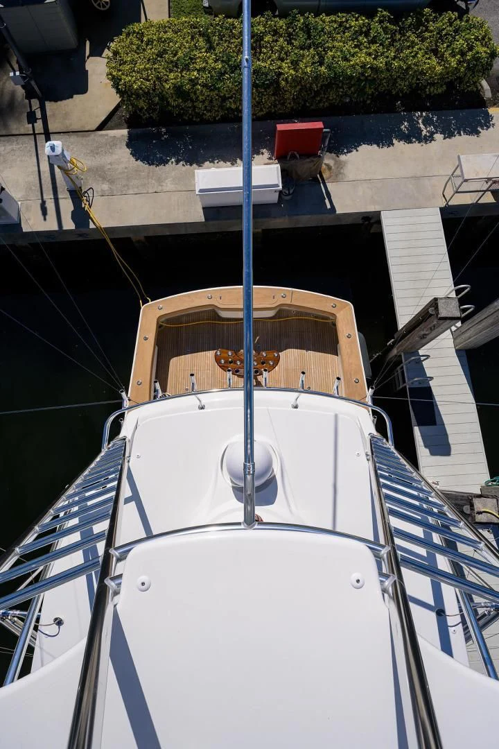 a white boat with a blue pole aboard TORO Yacht for Sale