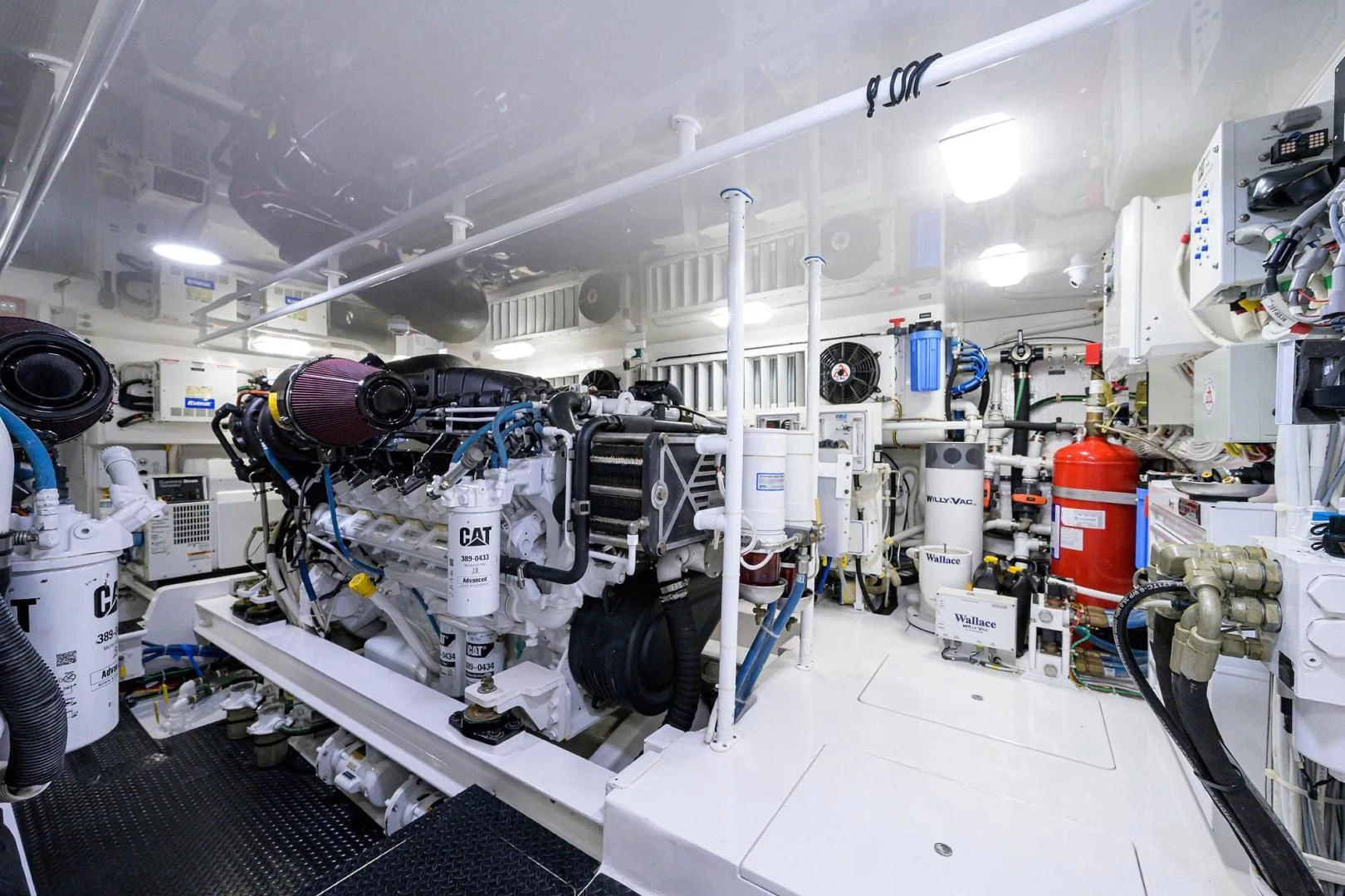 a large white machine with many black and white pipes aboard TORO Yacht for Sale