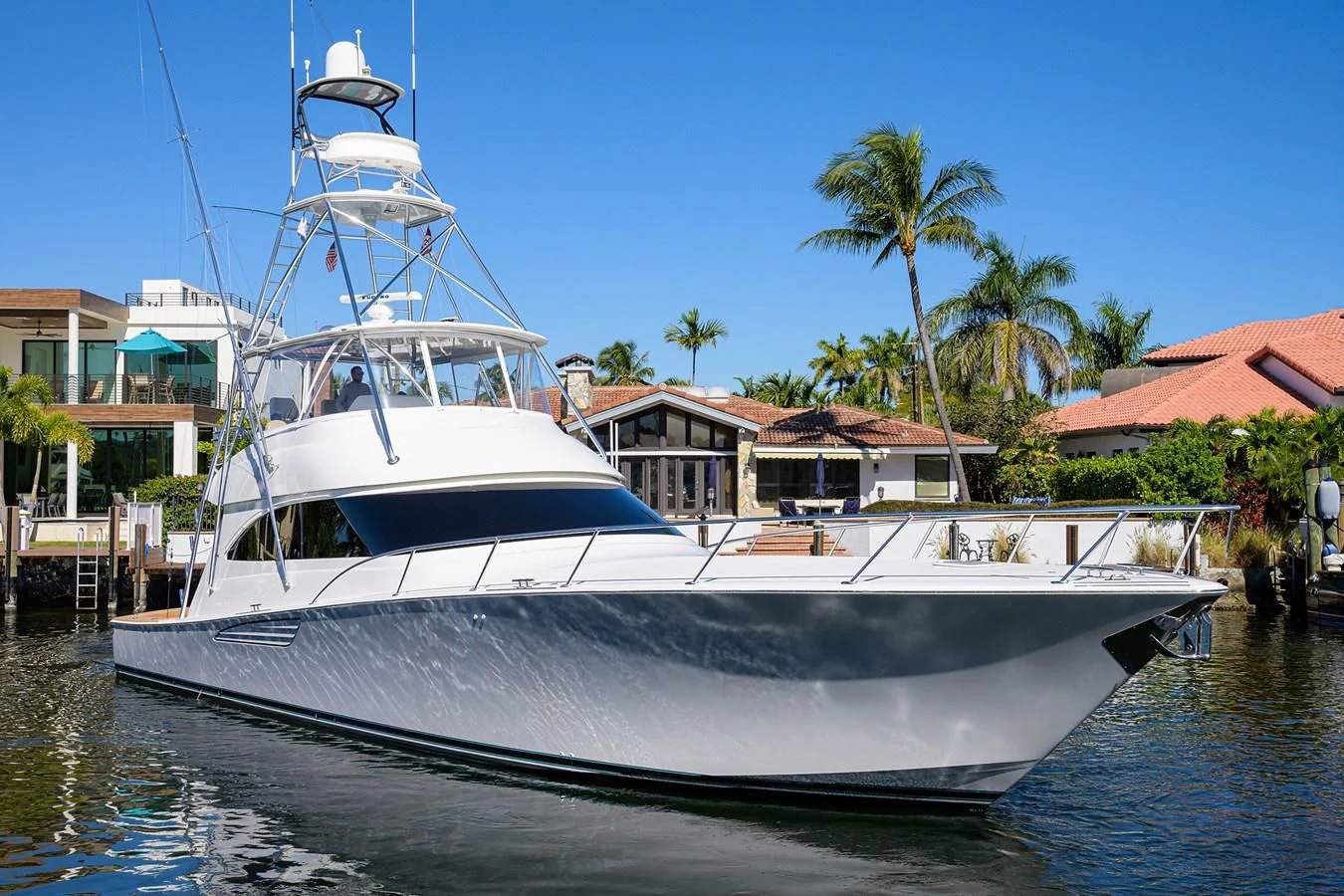 a white boat docked at a pier aboard TORO Yacht for Sale