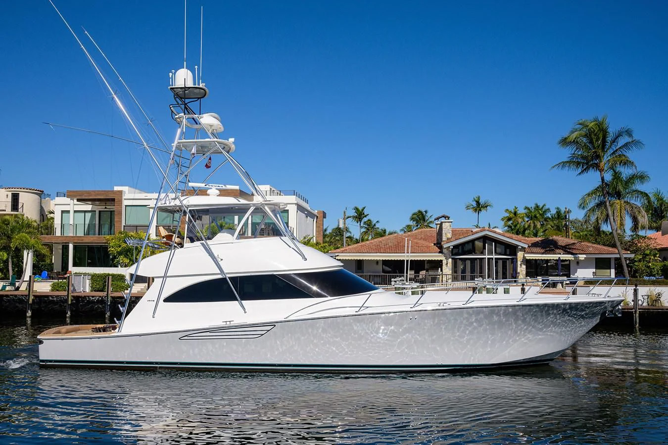 a white boat docked at a pier aboard TORO Yacht for Sale