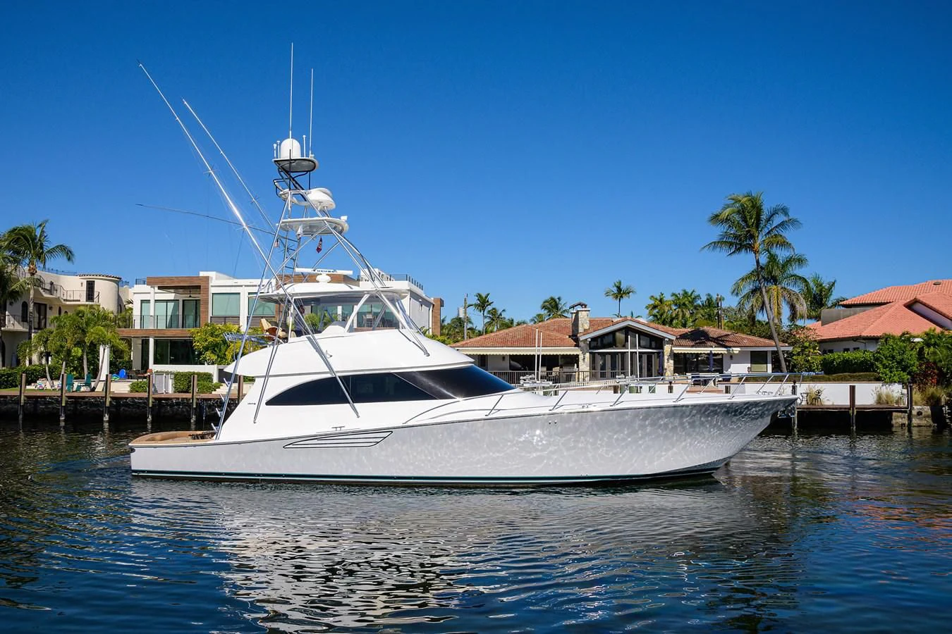 a white boat in a harbor aboard TORO Yacht for Sale