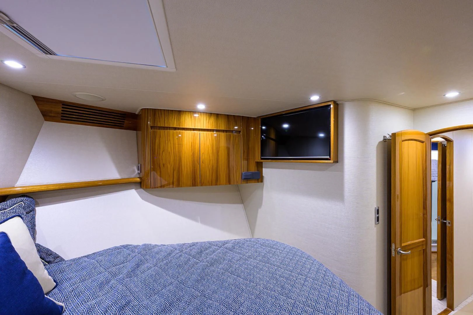 a bedroom with a bed and a television aboard TORO Yacht for Sale