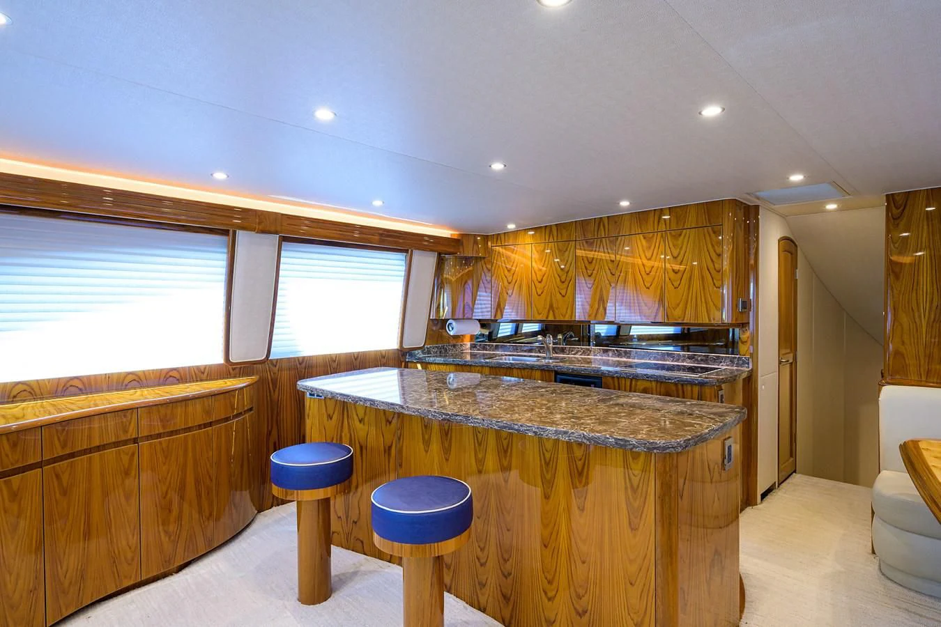a kitchen with a bar and stools aboard TORO Yacht for Sale
