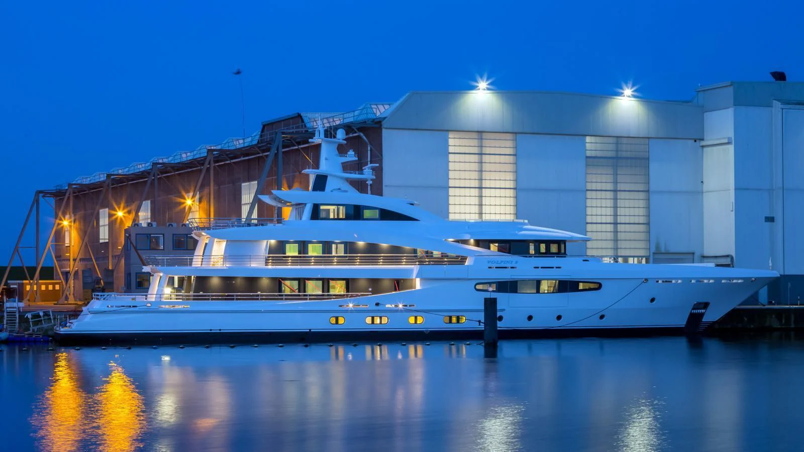 a large white yacht in front of a building aboard VOLPINI 2 Yacht for Sale