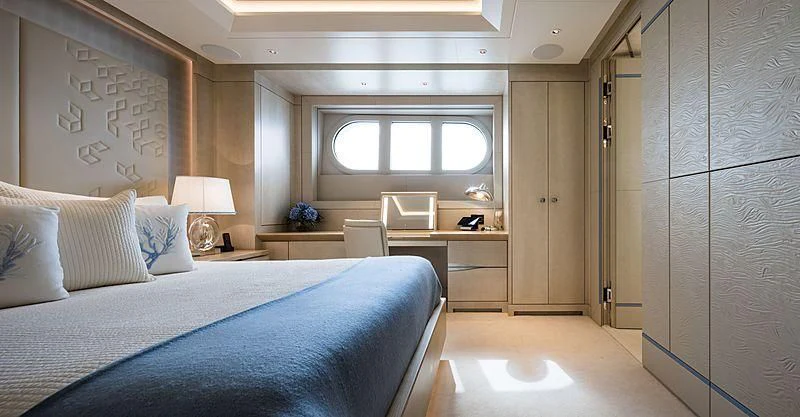 a bedroom with a bed and desk aboard VOLPINI 2 Yacht for Sale