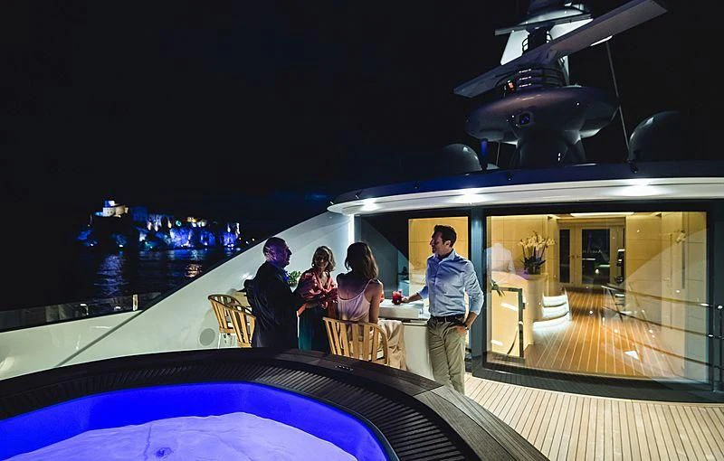 a group of people sitting on a deck looking out at the water aboard VOLPINI 2 Yacht for Sale