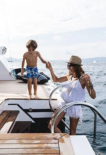 a couple of children on a boat aboard VOLPINI 2 Yacht for Sale
