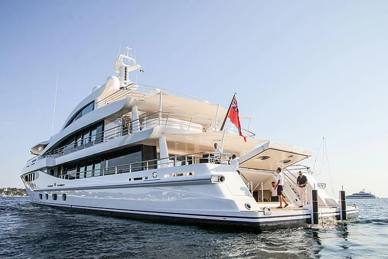 a large white boat with a flag on the front aboard VOLPINI 2 Yacht for Sale