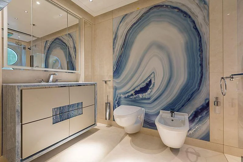 a bathroom with a blue shower curtain aboard VOLPINI 2 Yacht for Sale