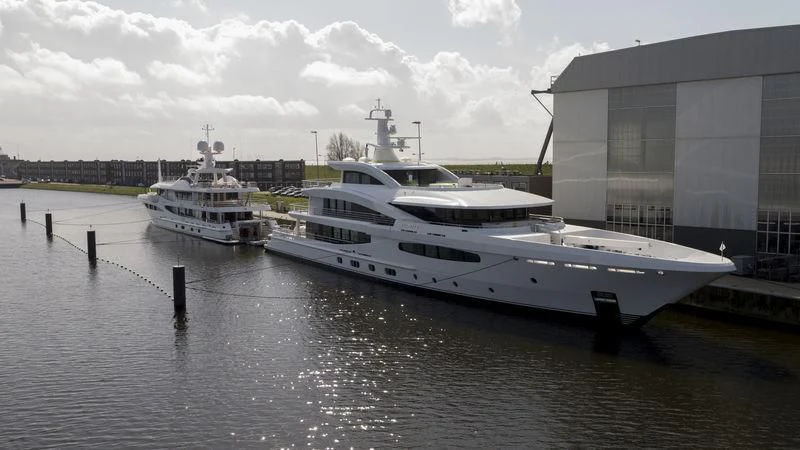 a couple of large white boats sit in a harbor aboard VOLPINI 2 Yacht for Sale