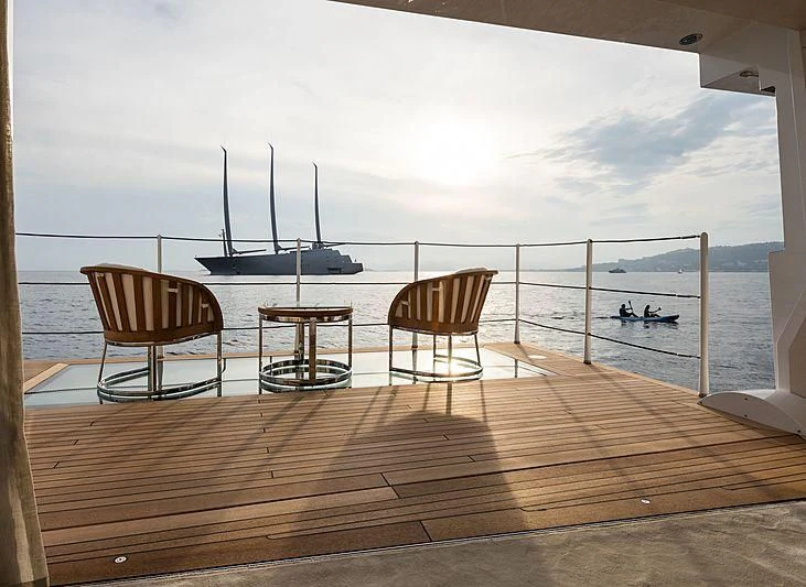 a deck with chairs and a table on it aboard VOLPINI 2 Yacht for Sale