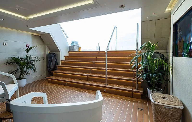 a room with a large window and a table with plants and a plant aboard VOLPINI 2 Yacht for Sale