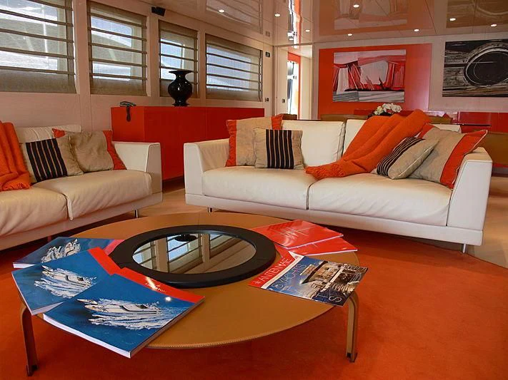 a living room with a table and couches aboard SOFIA Y Yacht for Sale