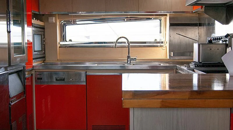 a kitchen with red cabinets aboard SOFIA Y Yacht for Sale