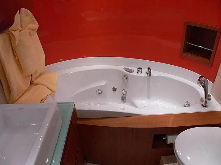 a bathroom with a tub sink and mirror aboard SOFIA Y Yacht for Sale