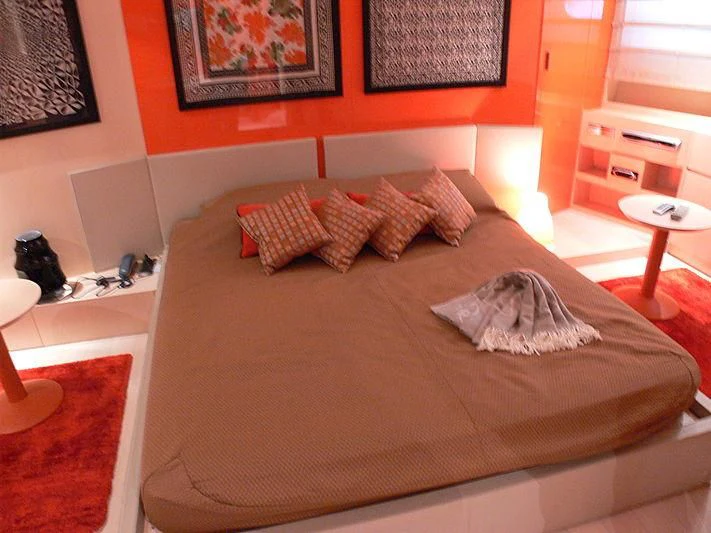 a bed with a brown comforter aboard SOFIA Y Yacht for Sale