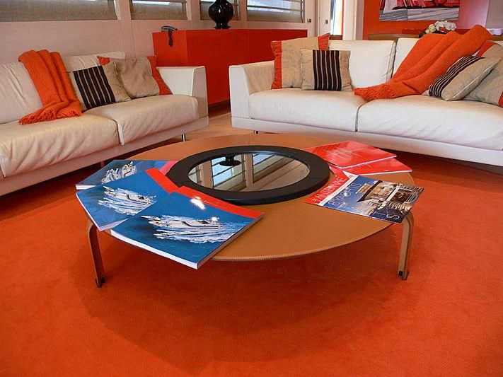 a living room with a round table aboard SOFIA Y Yacht for Sale